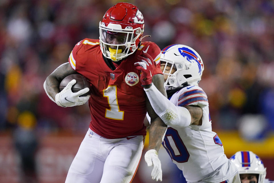 Kansas City Chiefs running back Jerick McKinnon (1) runs from Buffalo Bills cornerback Dane Jackson (30) during the second half of an NFL divisional round playoff football game, Sunday, Jan. 23, 2022, in Kansas City, Mo. (AP Photo/Ed Zurga)