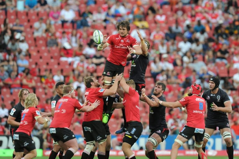 Lions' lock Franco Mostert (Top L) and Queensland Reds' flanker Scott Higginbotham (Top R) go for the ball in a line out during the Super XV rugby union match March 18, 2017 in Johannesburg