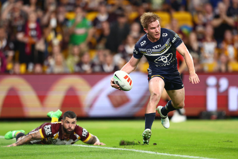 BRISBANE, AUSTRALIA - MARCH 29: Tom Dearden of the Cowboys runs the ball during the round four NRL match between Brisbane Broncos and North Queensland Cowboys at Suncorp Stadium, on March 29, 2024, in Brisbane, Australia. (Photo by Chris Hyde/Getty Images)