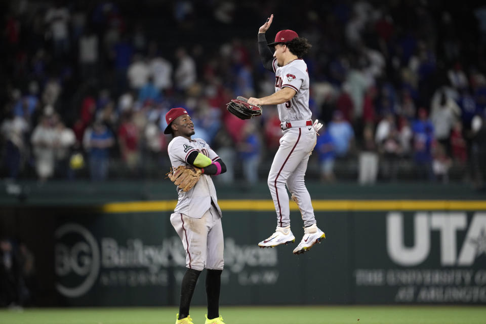 Arizona Diamondbacks' Alek Thomas (5) and Geraldo Perdomo celebrate after Game 2 of the baseball World Series against the Texas Rangers Saturday, Oct. 28, 2023, in Arlington, Texas. The Diamondbacks won 9-1. (AP Photo/Godofredo A. Vásquez)