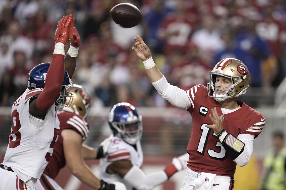 San Francisco 49ers quarterback Brock Purdy (13) passes as New York Giants linebacker Bobby Okereke applies pressure during the second half of an NFL football game in Santa Clara, Calif., Thursday, Sept. 21, 2023. (AP Photo/Godofredo A. Vásquez)