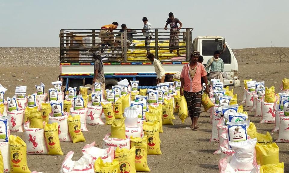 Displaced Yemenis receive food aid donated by a British organisation in Yemen’s western province of Hodeida.