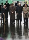 Former Boston Mayor Tom Menino, Boston Mayor Martin Walsh, Vice President Joe Biden and Mass. Gov. Deval Patrick lower their heads for a moment of silence during a tribute in honor of the one year anniversary of the Boston Marathon bombings, Tuesday, April 15, 2014 in Boston. (AP Photo/Charles Krupa)