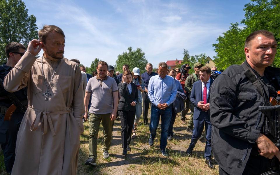 President of Moldova Maia Sandu, center, visits the Church of Saint Andrew the First-Called Apostle Andrii Halavin, in Bucha, Kyiv Region, northern Ukraine, June 27, 2022. - AP Photo/Nariman El-Mofty