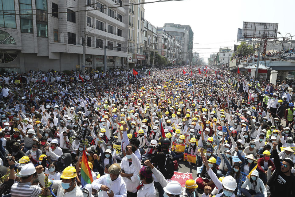 FILE - In this Feb. 22, 2021, file photo, hundreds of anti-coup protesters raise their hands with clenched fists during a rally near the Mandalay Railway Station in Mandalay, Myanmar. One hundred days since their takeover, Myanmar’s ruling generals maintain just the pretense of control over the country. There are fears the military takeover is turning Myanmar into a failed state. (AP Photo, File)