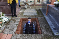 FILE - In this Wednesday, April 1, 2020 file photo, an undertaker prepares a grave during the burial of Rosalia Mascaraque, 86, during the coronavirus outbreak in Zarza de Tajo, central Spain. After the European Union passed the death toll of half a million citizens lost to the coronavirus on Wednesday, Feb. 10, 2021, the EU Commission chief said that stalling rollout of the vaccines could be partly blamed on the bloc being over-optimistic, over-confident and plainly "too late." (AP Photo/Bernat Armangue, File)