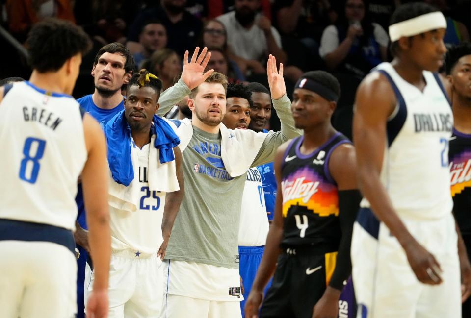 May 15, 2022; Phoenix, Arizona, USA; Dallas Mavericks guard Luka Doncic (77) watches the action from the bench in the fourth quarter during their victory over the Phoenix Suns during game seven of the second round for the 2022 NBA playoffs at Footprint Center.