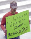 FILE - In this March 17, 2017, file photo, a protester holds a sign during a rally at the Utah State Capitol in Salt Lake City. Utah's governor has announced he will sign legislation giving the state the strictest DUI threshold in the country. Republican Gov. Gary Herbert on Thursday, March 23 said he plans to approve the measure lowering the blood alcohol limit to .05 percent from .08 percent. Restaurant groups and representatives of the ski and snowboard industry had urged him to veto the bill, arguing it would hurt Utah's image. (AP Photo/Rick Bowmer, File)