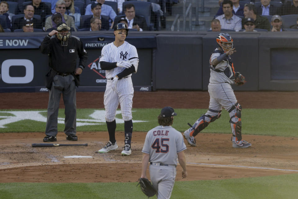 Houston Astros catcher Martin Maldonado, right, motions to starting pitcher Gerrit Cole (45) after Col struck out New York Yankees' Aaron Judge with two men on base to end the second inning against the Houston Astros during Game 3 of baseball's American League Championship Series, Tuesday, Oct. 15, 2019, in New York. (AP Photo/Seth Wenig)