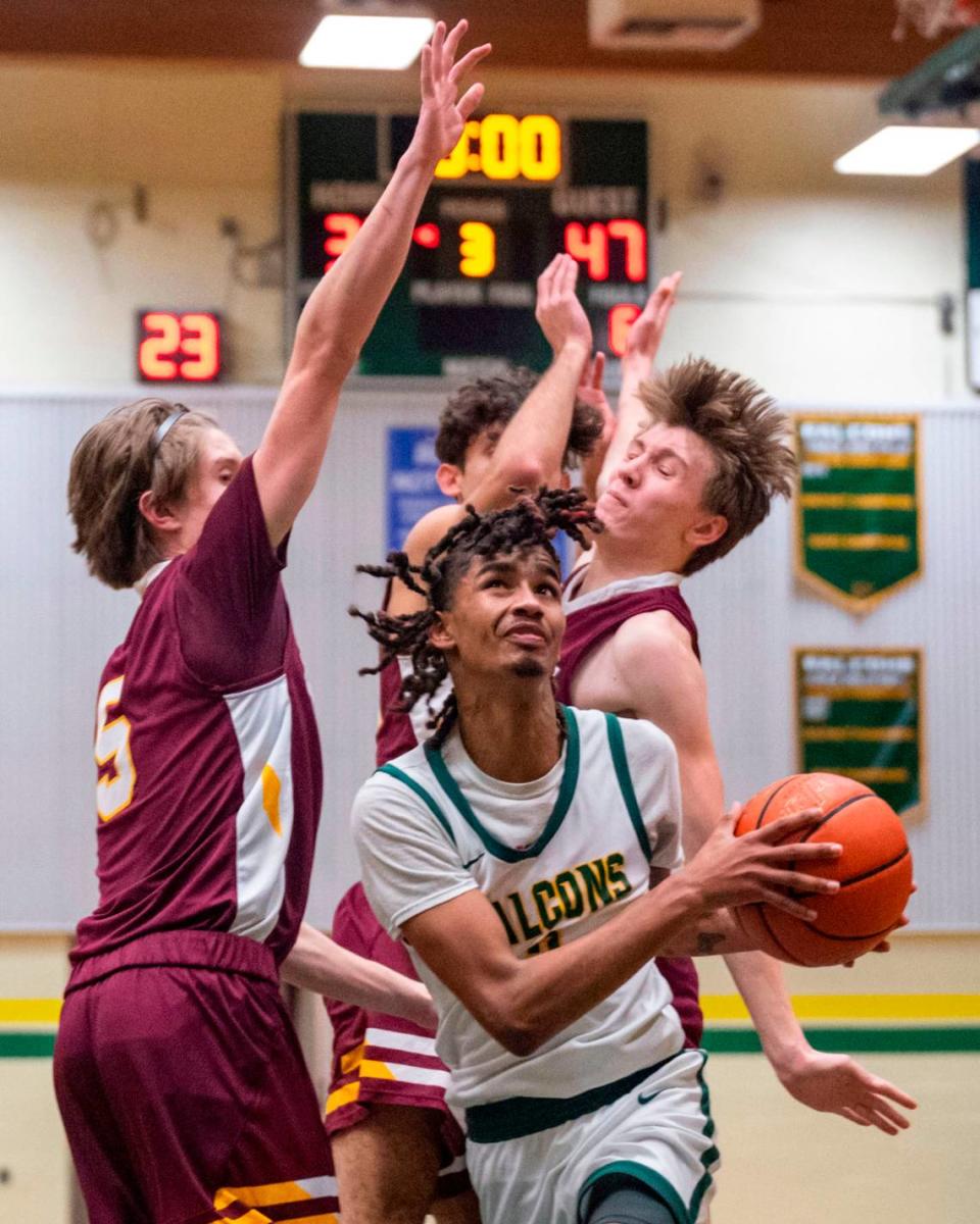 Foss’s Jamie Killian-Howard slips through a trio of Enumclaw defenders on his way to the hoop during the third quarter of 2A SPSL game on Tuesday, Jan. 24, 2023, in Tacoma, Wash.