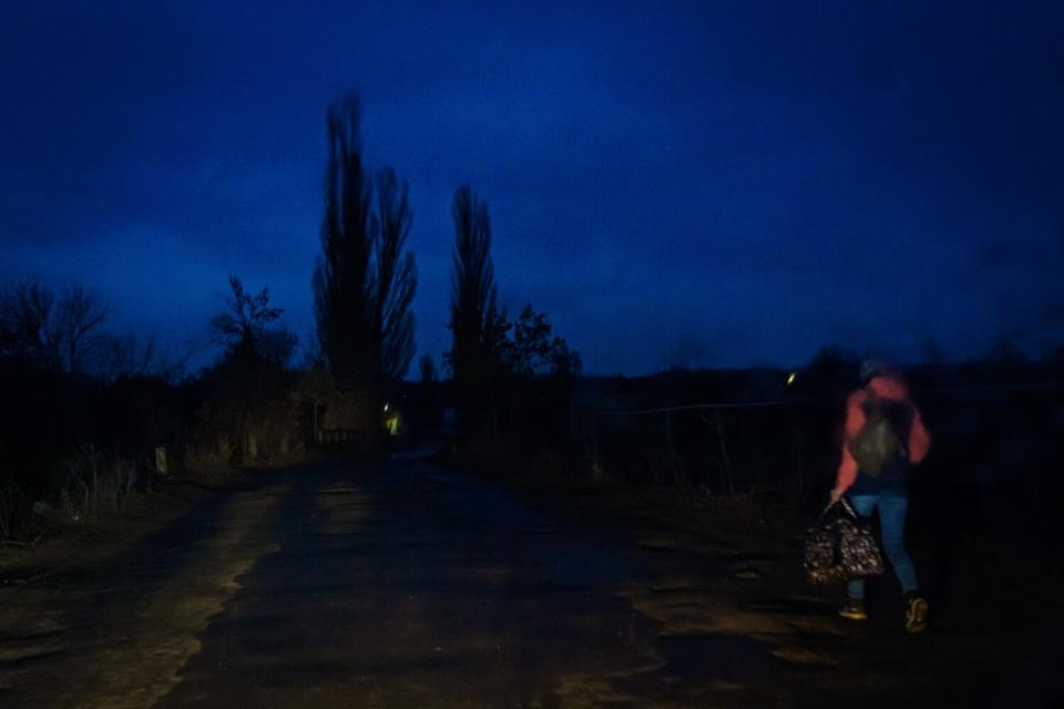 A person walks through the rain in New York, Ukraine