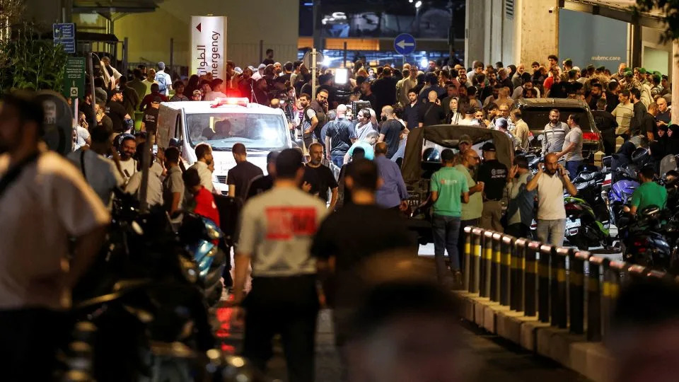 People gather outside the American University of Beirut Medical Center, which saw an influx of injured patients after explosions in Lebanon's capital on September 17. - Mohamed Azakir/Reuters