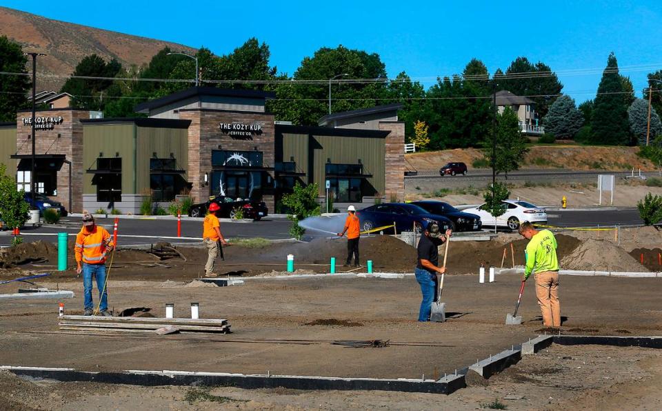 Construction crews work near the concrete foundation for the new Ehtos Bakery & Cafe in Richland.