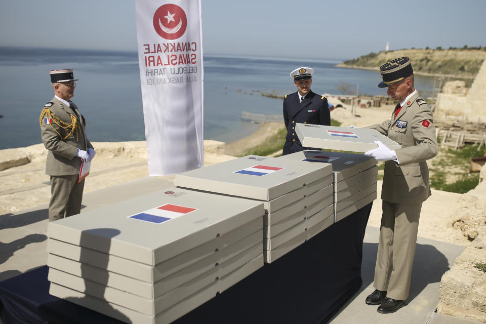 French army officers prepare the remains of 17 missing French soldiers who fought in the World War I Battle of Gallipoli, in Canakkale, Turkey, Sunday, April 24, 2022. The remains were on Sunday handed over to French military officials and put to rest alongside other fallen comrades, more than a hundred years after their deaths. The remains were found during restoration work on a castle and surrounding areas on Turkey's northwestern Canakkale peninsula, where Allied forces fought against Ottoman Turks in the ill-fated Gallipoli campaign that started with landings on the peninsula on April 25, 1915. (AP Photo/Emrah Gurel)