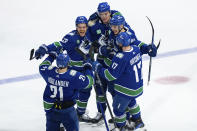 Vancouver Canucks' Nils Hoglander, Teddy Blueger, Nikita Zadorov, Ilya Mikheyev and Filip Hronek celebrate Zadorov's goal against the Edmonton Oilers during the third period of Game 1 of a second-round NHL hockey Stanley Cup playoffs series, Wednesday, May 8, 2024, in Vancouver, British Columbia. (Ethan Cairns/The Canadian Press via AP)