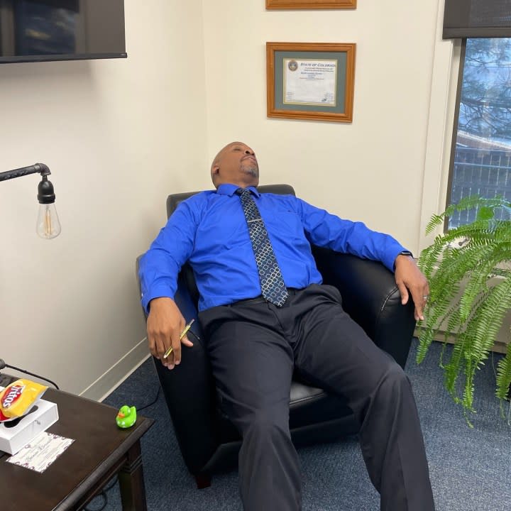 Widefield School District 3 Superintendent Kevin Duren sleeping on a chair for April Fools'