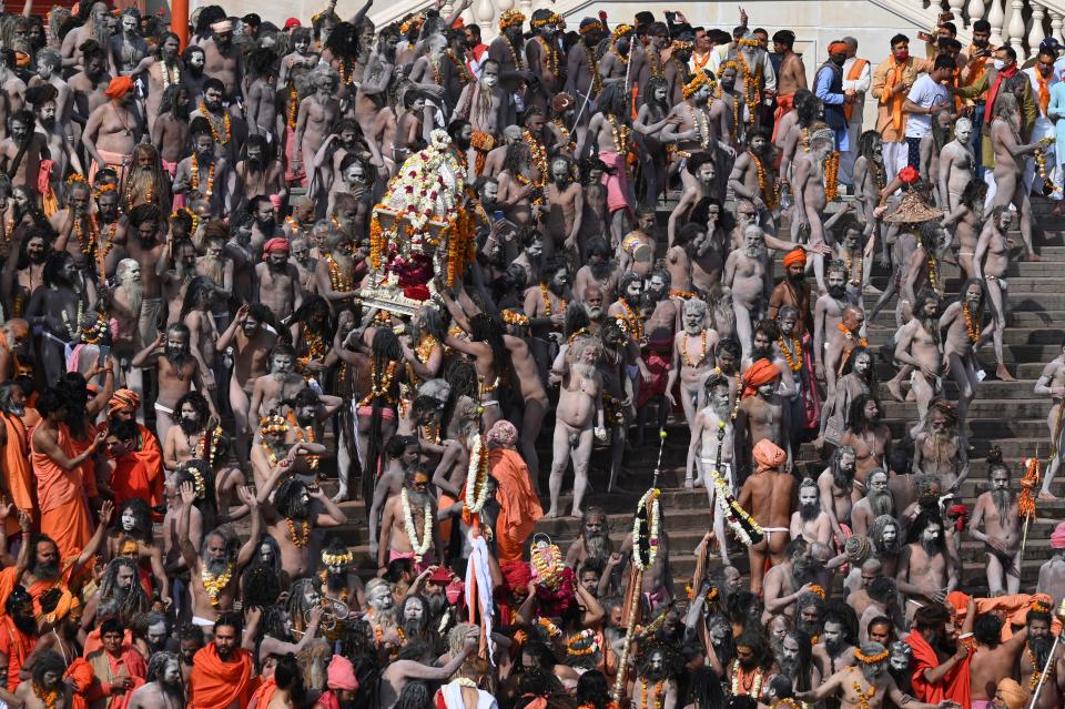 TOPSHOT - Naga Sadhus (Hindu holy men) gather before taking holy dip in the waters of the River Ganges on the Shahi snan (grand bath) on the occasion of Maha Shivratri festival during the ongoing religious Kumbh Mela festival in Haridwar on March 11, 2021. (Photo by Prakash SINGH / AFP) (Photo by PRAKASH SINGH/AFP via Getty Images)