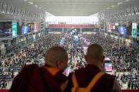 Monks take pictures with phone at Shanghai Hongqiao railway station ahead of the five-day Labour Day holiday, in Shanghai