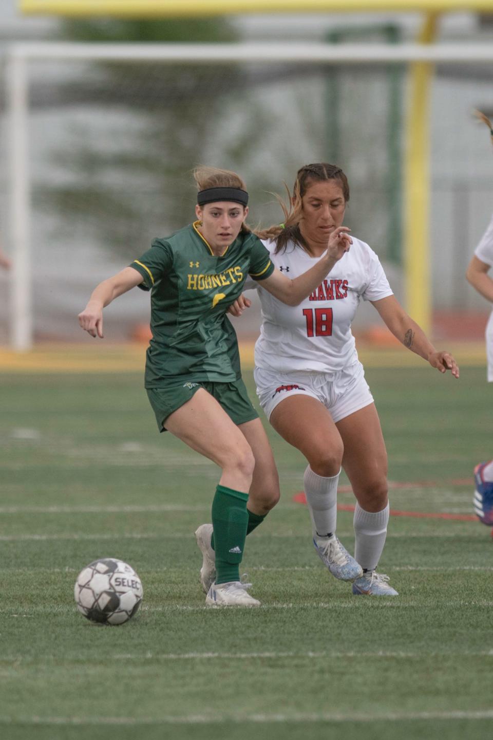 Pueblo County's Pierson Weimer, left, battles for possession with a Montrose defender during a playoff matchup on Wednesday, May 10, 2023.