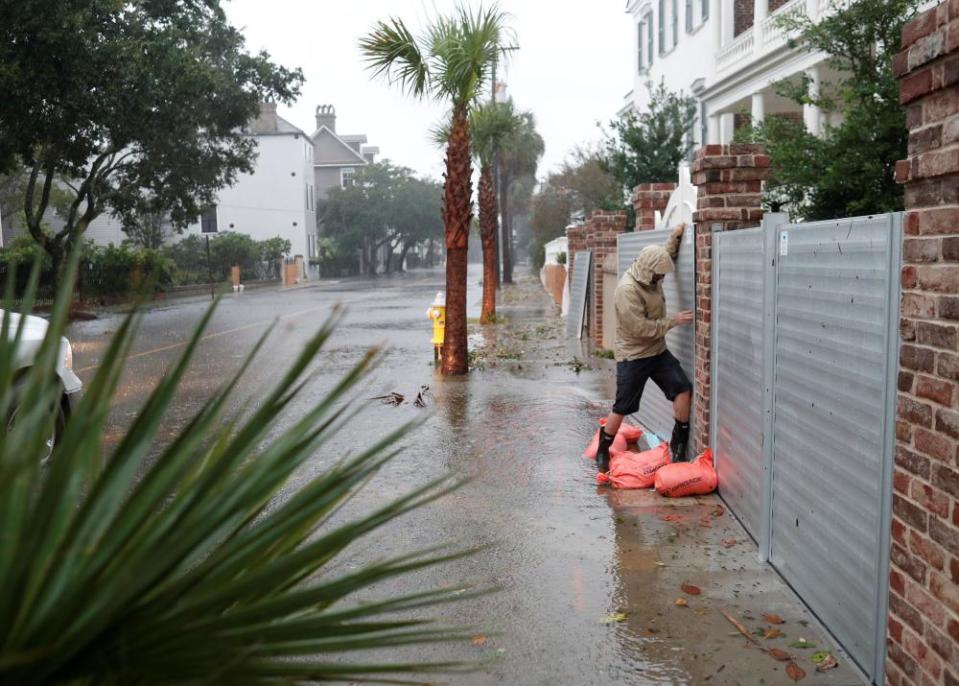Brys Stephens struggles to install a metal flood gate along South Battery during Hurricane Dorian in Charleston, South Carolina on 5 September 2019.