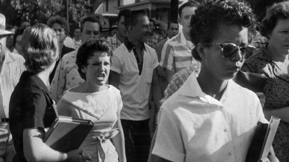 Hazel Bryan, center left, and other students of Central High School in Little Rock, Arkansas, shout insults at Elizabeth Eckford as she calmly walks to a line of National Guardsmen who blocked the main entrance and would not let her enter on September 4, 1957. - Will Counts/Arkansas Democrat Gazette via AP
