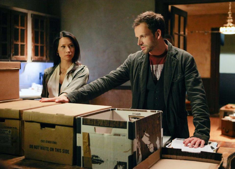 This publicity image released by CBS shows Jonny Lee Miller, right, and Lucy Liu in a scene from the series, "Elementary." (AP Photo/CBS, Giovanni Rufino)