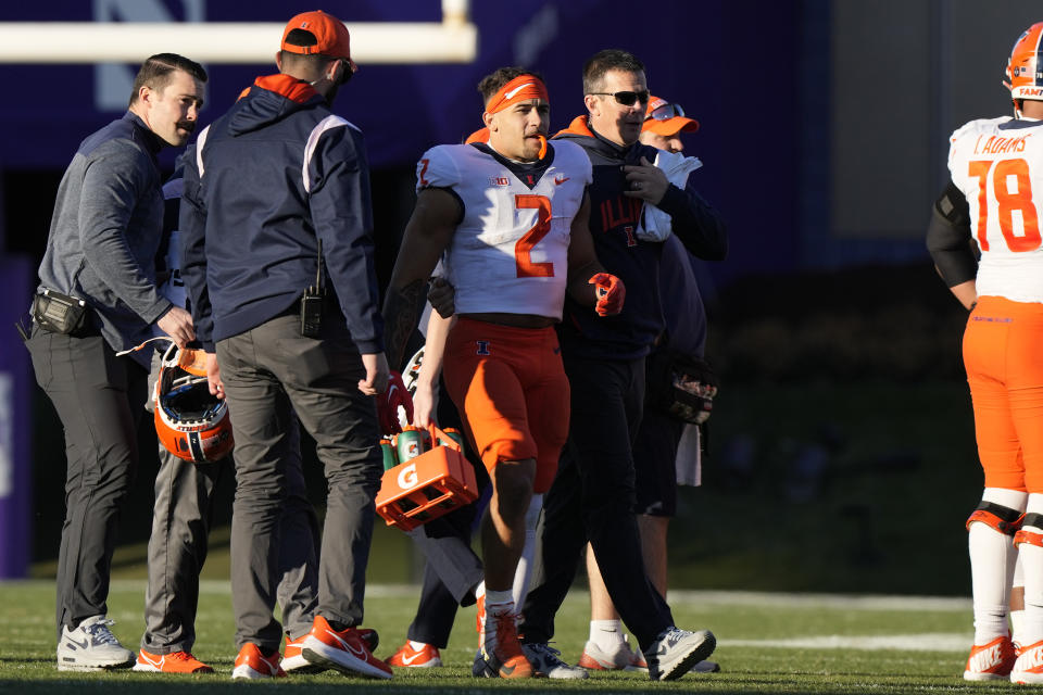 Illinois running back Chase Brown (2) is helped by medical personel during the first half of an NCAA college football game against Northwestern in Evanston, Ill., Saturday, Nov. 26, 2022. (AP Photo/Nam Y. Huh)