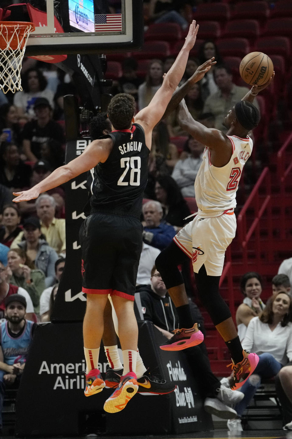 Miami Heat forward Jimmy Butler (22) shoots as Houston Rockets center Alperen Sengun (28) defends during the first half of an NBA basketball game Friday, Feb. 10, 2023, in Miami. (AP Photo/Lynne Sladky)