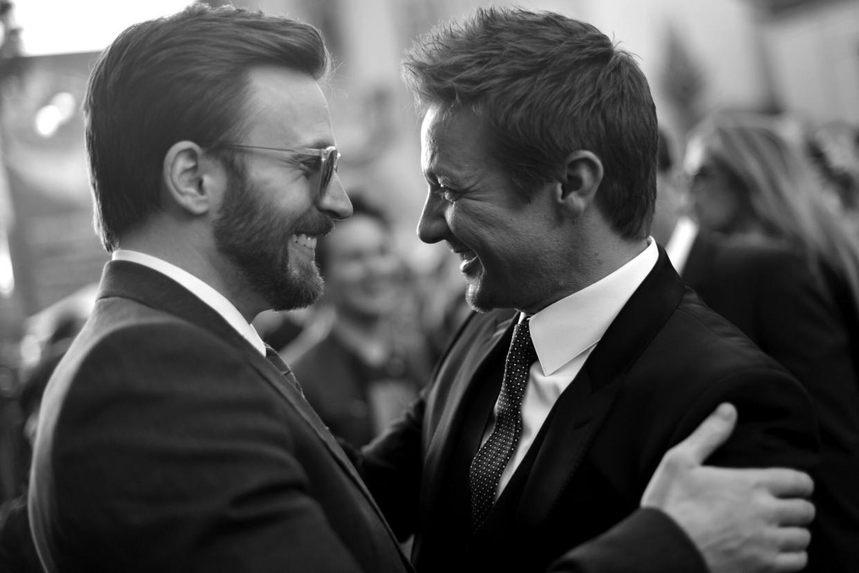 HOLLYWOOD, CA - MARCH 13: (EDITORS NOTE: Image shot on black and white film. Color version not available.) Actors Chris Evans (L) and Jeremy Renner attend Marvel's "Captain America: The Winter Soldier" premiere at the El Capitan Theatre on March 13, 2014 in Hollywood, California. (Photo by Charley Gallay/Getty Images for Disney)