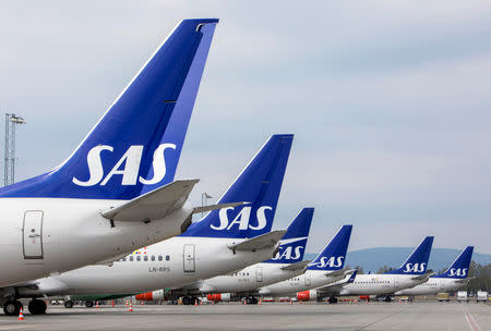 SAS airplanes are seen parked on the tarmac as SAS pilots go on strike at Oslo Airport in Gardermoen, Norway April 26, 2019. NTB Scanpix/Ole Berg-Rusten via REUTERS ATTENTION EDITORS - THIS IMAGE WAS PROVIDED BY A THIRD PARTY. NORWAY OUT. NO COMMERCIAL OR EDITORIAL SALES IN NORWAY.