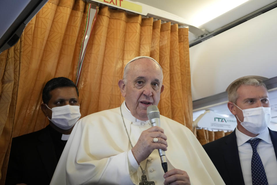 Pope Francis greets the journalists onboard the papal plane on the occasion of his five-day pastoral visit to Cyprus and Greece, Thursday, Dec. 2, 2021.(AP Photo/Alessandra Tarantino, Pool)