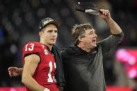 Georgia head coach Kirby Smart and Georgia quarterback Stetson Bennett (13) celebrate victory over TCU after the national championship NCAA College Football Playoff game, Monday, Jan. 9, 2023, in Inglewood, Calif. Georgia won 65-7. (AP Photo/Ashley Landis)