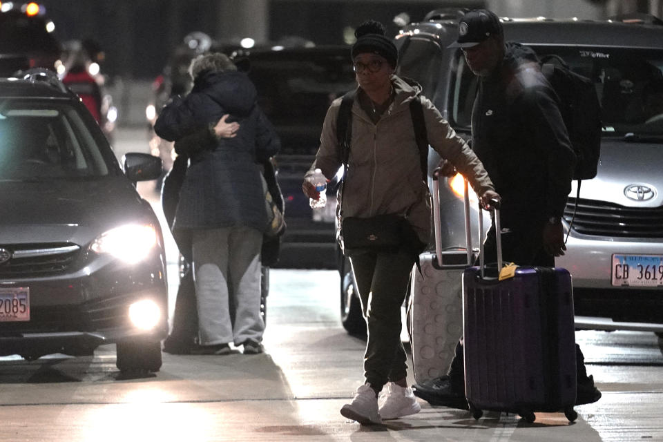 Travelers walk to a ticketing desk at the O'Hare International Airport in Chicago, Thursday, Dec. 21, 2023. It's beginning to look a lot like a hectic holiday travel season, but it might go relatively smoothly if the weather cooperates. (AP Photo/Nam Y. Huh)