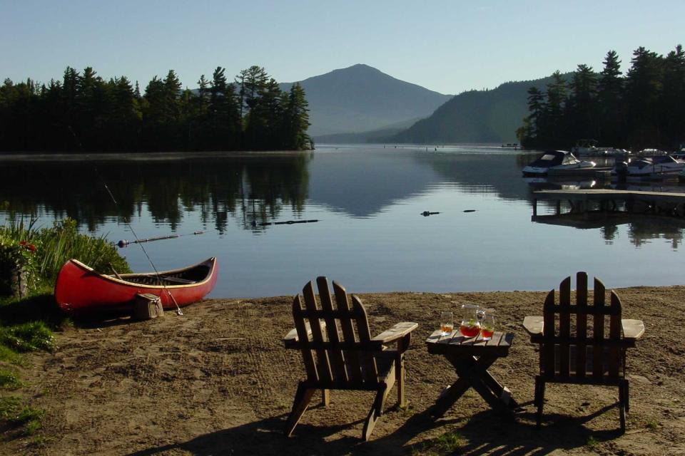 Canoe and lake side seating at Whiteface Lodge