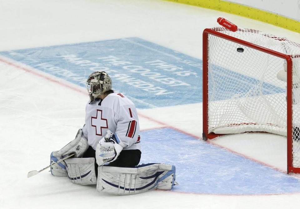 Switzerland's Melvin Nyffeler lets in a goal by Canada's Derrick Pouliot, not pictured, during the third period of their IIHF World Junior Championship ice hockey game in Malmo, Sweden, January 2, 2014. REUTERS/Alexander Demianchuk (SWEDEN - Tags: SPORT ICE HOCKEY)