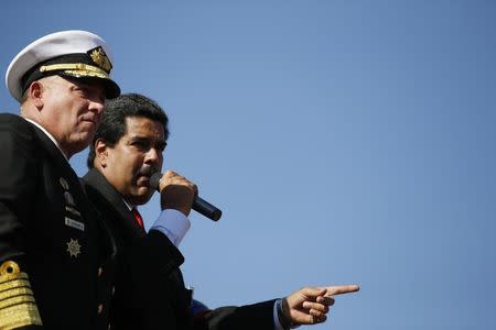 FILE PHOTO: Nicolas Maduro stands next to then Defense Minister Diego Molero (L) as he speaks to thousands of supporters of Venezuela's late President Hugo Chavez as they wait to view his body in state at the Military Academy in Caracas March 7, 2013. REUTERS/Jorge Silva