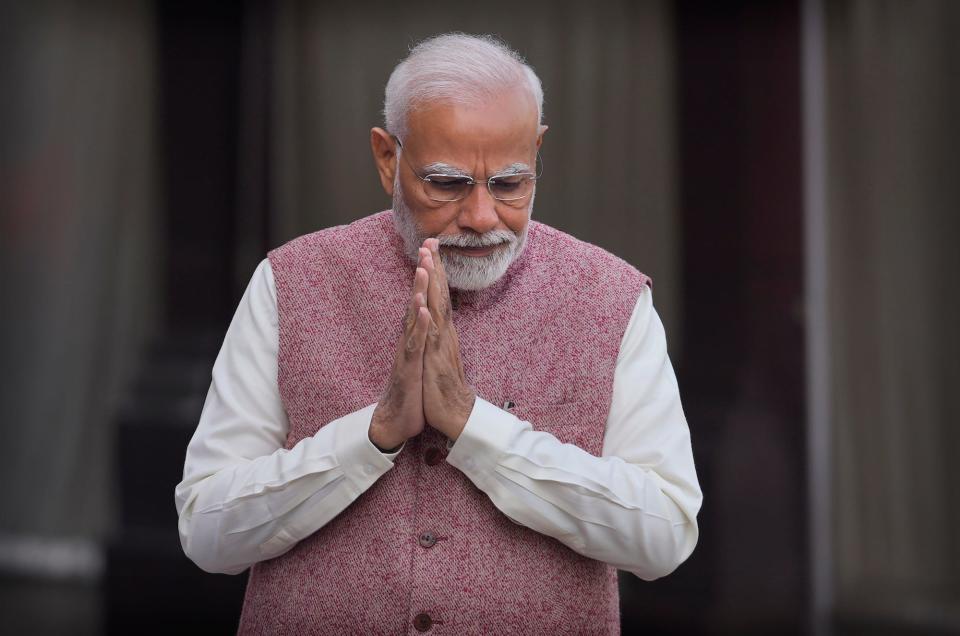 Indian Prime Minister Narendra Modi greets his cabinet colleagues as he arrives on the opening day of the winter session of the Parliament, in New Delhi, India, on December 7, 2022.