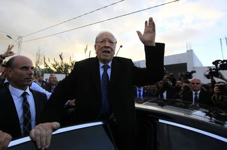Beji Caid Essebsi (C), leader of Tunisia's secular Nidaa Tounes party and a presidential candidate, gestures after casting his vote at a polling station in Tunis December 21, 2014. REUTERS/Anis Mili