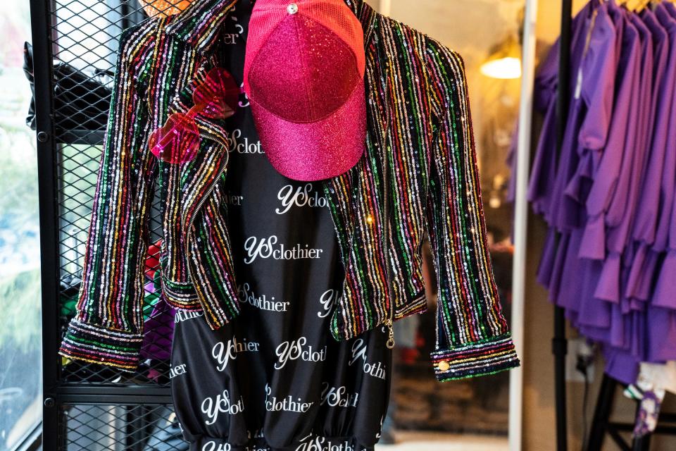 A Sequin hat, jacket, scrunchie and custom brand logo bubble shirt dress are shown as gift items for holiday shoppers at the space for Young Socialites Clothier in the Downtown Detroit Markets located at Cadillac Square in downtown Detroit on Wednesday, November 30, 2022.