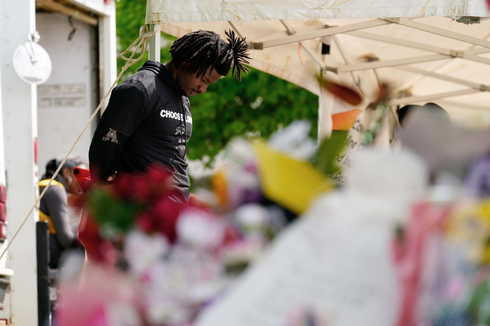 Buffalo Bills' Josh Thomas visits the scene of Saturday's shooting at a supermarket, in Buffalo, N.Y., Wednesday, May 18, 2022. (AP Photo/Matt Rourke)