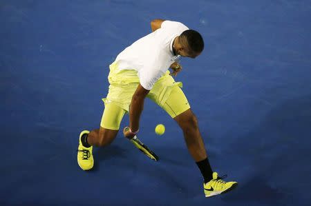 Nick Kyrgios of Australia hits a return between his legs against Andy Murray of Britain during their men's singles quarter-final match at the Australian Open 2015 tennis tournament in Melbourne January 27, 2015. REUTERS/Carlos Barria