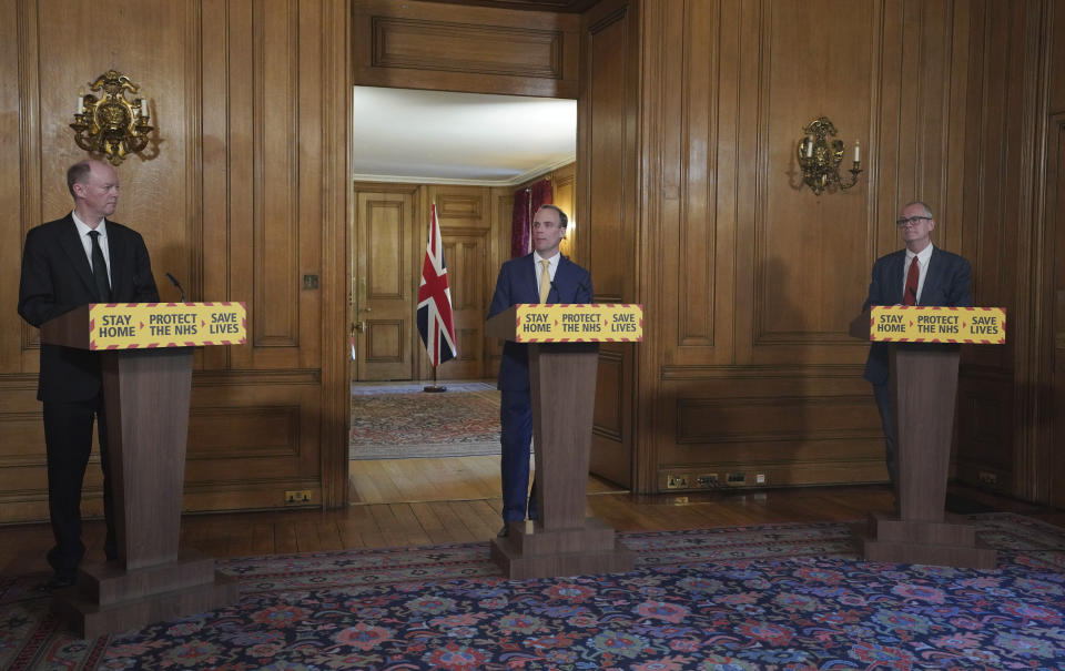 In this handout photo provided by 10 Downing Street, from left, Britain's Chief Medical Officer, Chris Whitty, Foreign Secretary Dominic Raab and Chief Scientific Adviser Sir Patrick Vallance during a media briefing on coronavirus in Downing Street, London, Tuesday, April 7, 2020. British Prime Minister Boris Johnson remained in intensive care Tuesday with coronavirus at the NHS St Thomas' Hospital in central London. The new coronavirus causes mild or moderate symptoms for most people, but for some, especially older adults and people with existing health problems, it can cause more severe illness or death. (Pippa Fowles/10 Downing Street via AP)