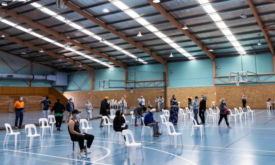 People wait for the AstraZeneca vaccine at the pop-up, walk-in clinic at the Michael Wenden Aquatic Leisure Centre in Miller in Sydney’s south-west.