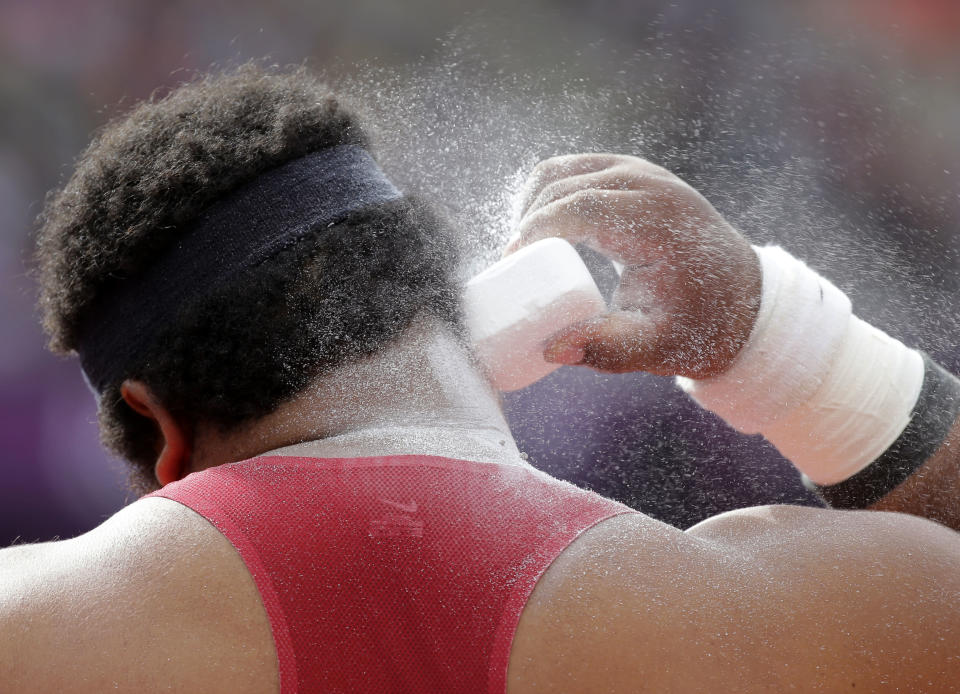 Reese Hoffa of the United States prepares for an attempt in the men's shot put qualification during the athletics in the Olympic Stadium at the 2012 Summer Olympics, London, Friday, Aug. 3, 2012. (AP Photo/David J. Phillip )