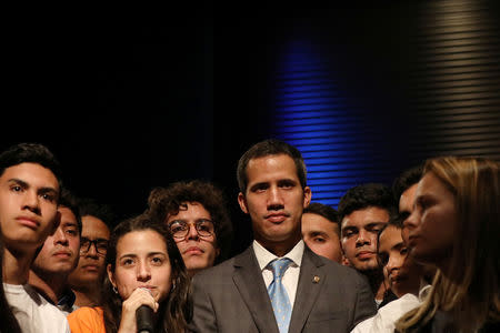 Venezuelan opposition leader Juan Guaido, who many nations have recognized as the country's rightful interim ruler, is seen with students in Caracas, Venezuela February 11, 2019. REUTERS/Andres Martinez Casares