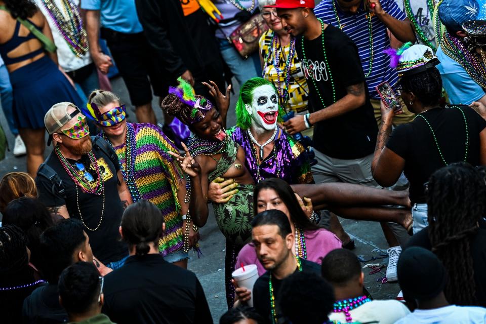 Revelers pose for pictures as they party in the streets of the French Quarter during the Mardi Gras Festival in New Orleans, Louisiana, on Feb. 20, 2023.