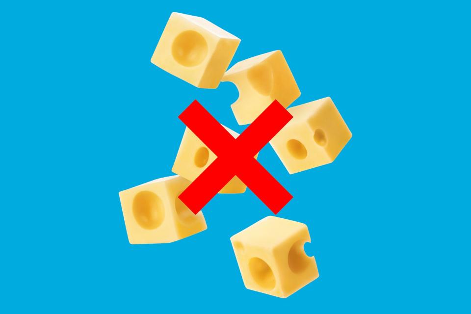 a photo of cubed swiss cheese with a red X over it