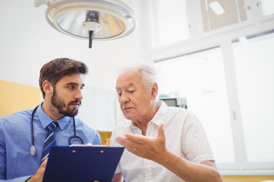 Senior man talking to doctor.