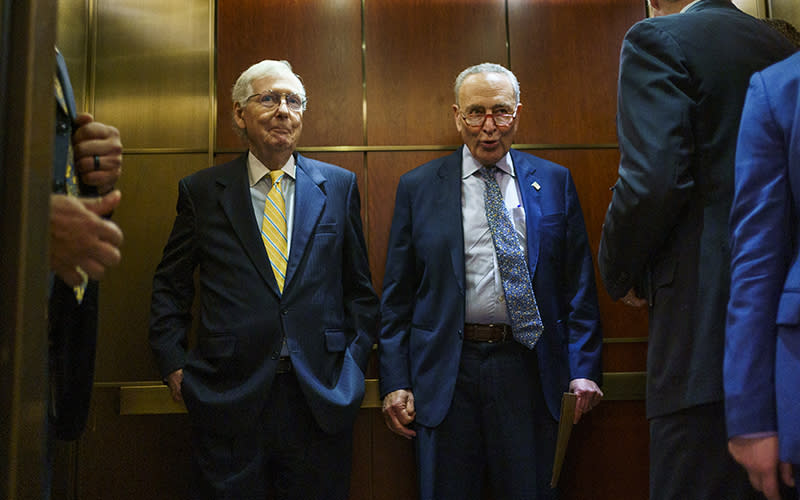 Minority Leader Mitch McConnell (R-Ky.) and Majority Leader Chuck Schumer (D-N.Y.) ride an elevator to an all-Senators briefing