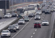 A car drives in the opposite direction, where a highway was blocked, during a protest in Belgrade, Serbia, Saturday, Jan. 15, 2022. Hundreds of environmental protesters demanding cancelation of any plans for lithium mining in Serbia took to the streets again, blocking roads and, for the first time, a border crossing. Traffic on the main highway north-south highway was halted on Saturday for more than one hour, along with several other roads throughout the country, including one on the border with Bosnia. (AP Photo/Darko Vojinovic)